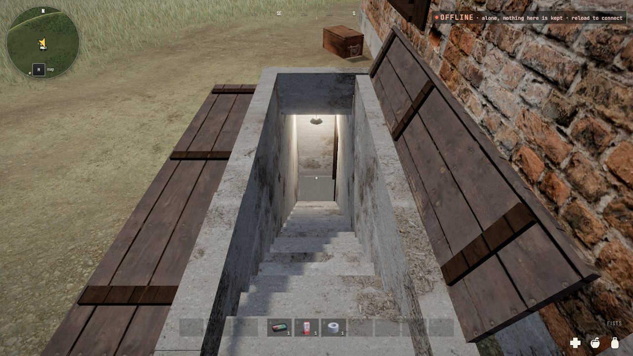 A cellar door beside a brick house: a concrete kerb round steps going down into the ground, one plank leaf thrown back on the grass and the other leant against the house wall, a light at the bottom of the steps
