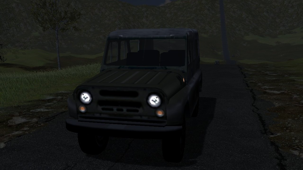The jeep on the road at night with both headlamps lit