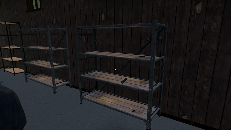 Steel racks with wooden boards along the plank wall of a barn, a flashlight and rounds on them