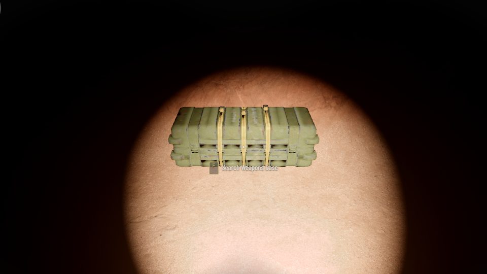 An olive army hard case on a cave floor, lit by a flashlight in the dark