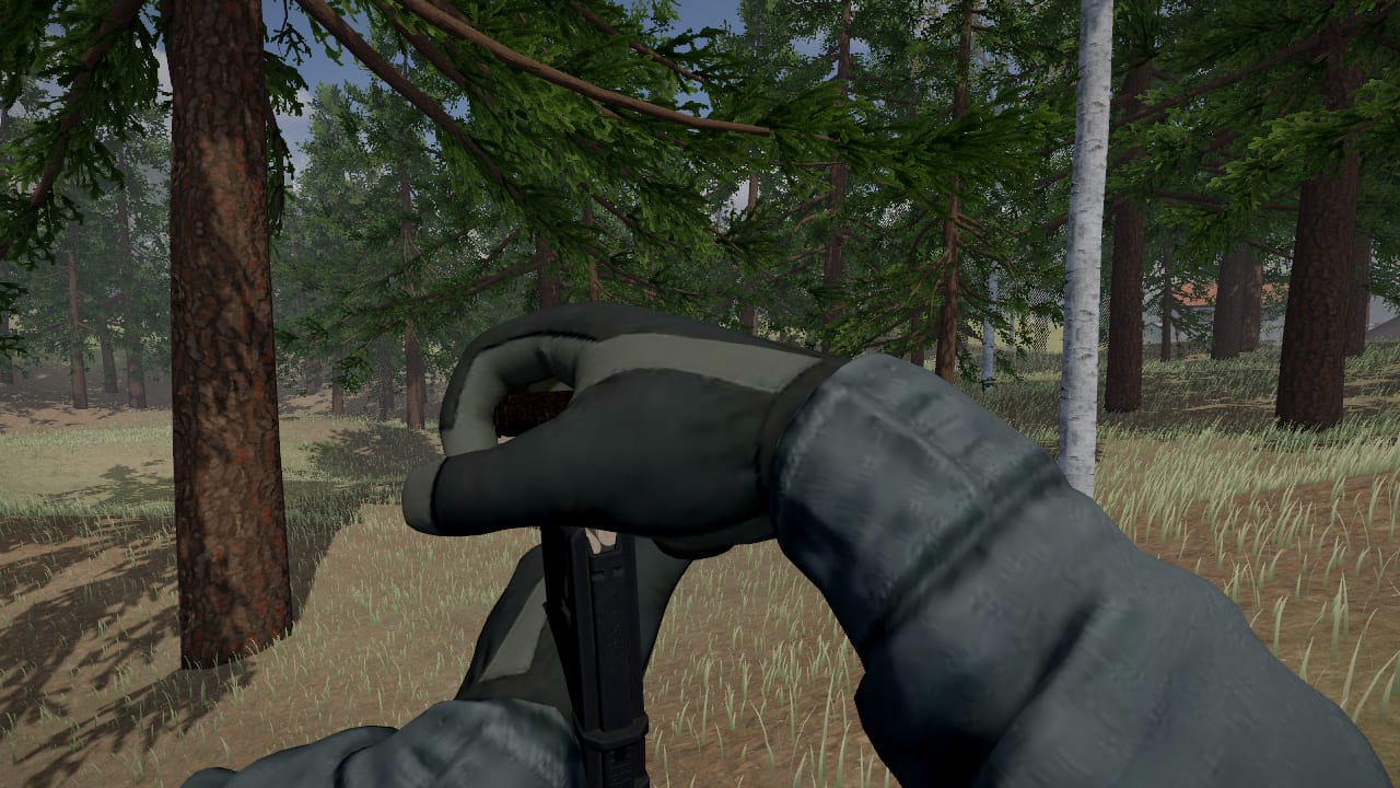 First person: an AR magazine upright in the left hand, the right hand on top of it pressing a round in