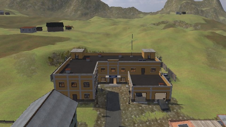 The headquarters from above: the main block of two floors and two lower wings before it, flat roofs with a room over each stair, steel stairs up the end wall, a fence round the back